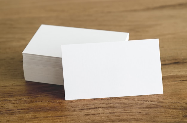 Photo blank business cards on wooden table.