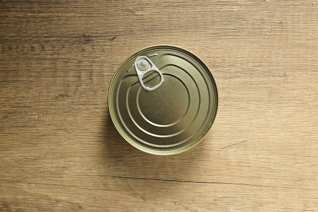 Blank canned food jar on wooden background