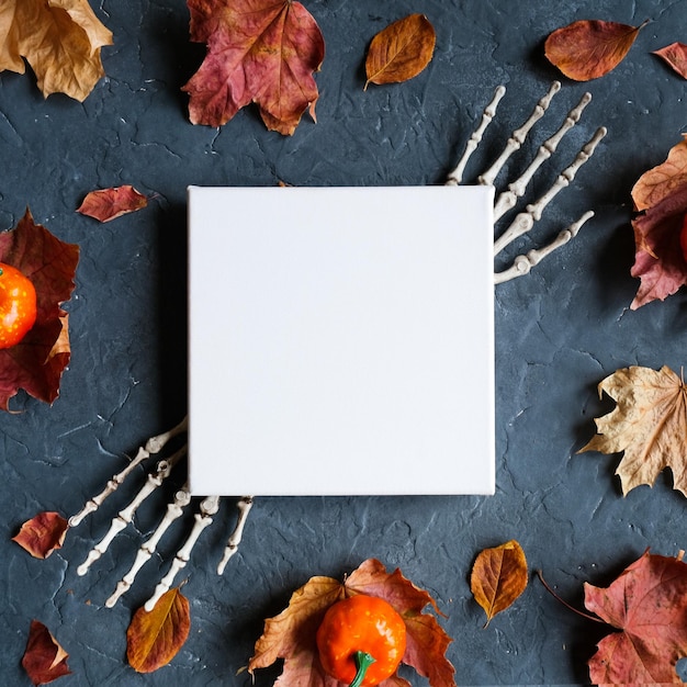 Blank canvas frame and halloween decoration on dark
background