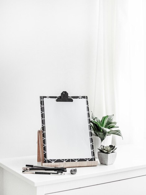 Photo blank canvas green plants on white wooden table