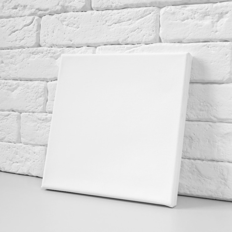 Photo blank canvas or mockup poster frame against brick wall