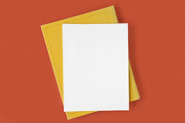 Blank canvas sheet with pen on red orange background Top view flat lay copy space Net white page