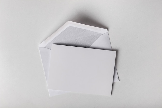 Blank card and envelope over white background