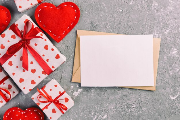 blank card, gift box with hearts wrapping paper and textile hearts