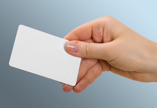 Blank card  in hand on background