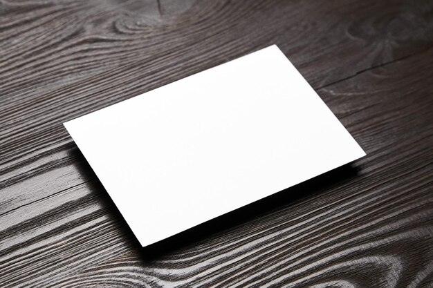 Blank card mockup on wooden background White empty holiday card mock up on brown table
