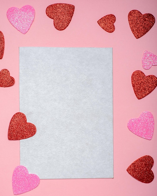 Blank card surrounded by hearts on a pink background Mockup for Valentine's  Day