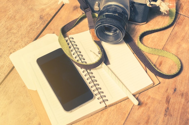 Photo blank cell phone diary and old photo camera vintage photo effect