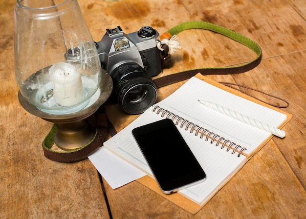 Blank cell phone diary and old photo camera