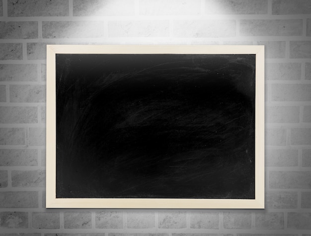 Blank chalkboard, blackboard hanging on the white brick wall with copy space