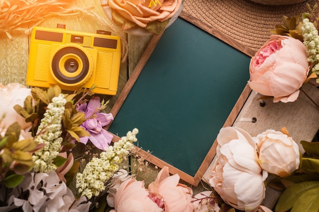 blank chalkboard  and retro camera with flower