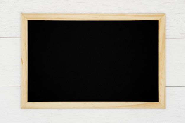 Blank chalkboard on white wood plank background