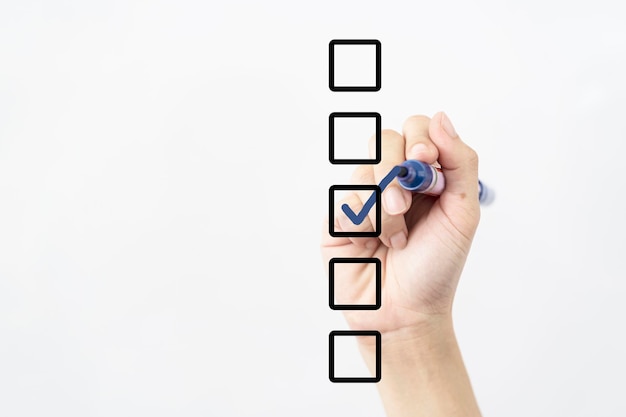 Blank checklist on whiteboard with businessman hand drawing a blue check mark in one checkbox