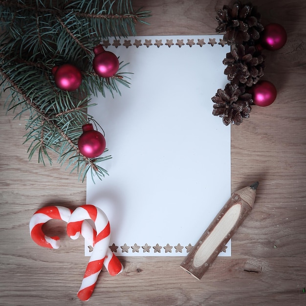 Blank christmas card and ornaments on wooden background