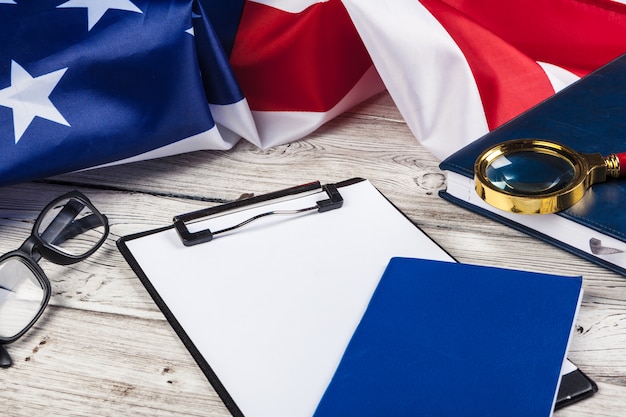 blank clip board and USA flag on wooden table