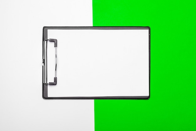 Blank clipboard paper on bright green paper, copy space