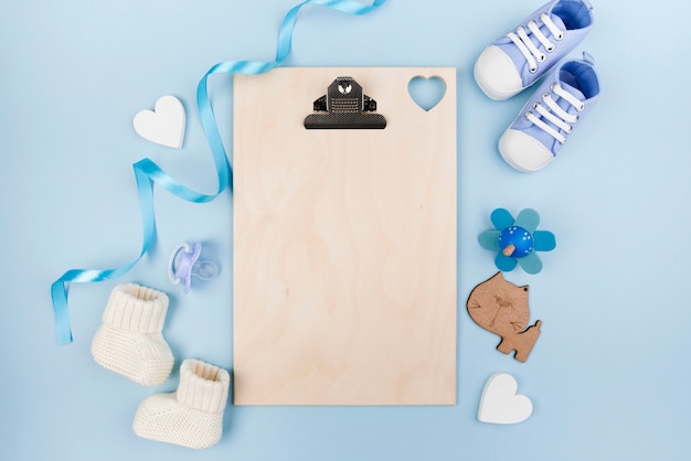 Blank clipboard with baby shoes