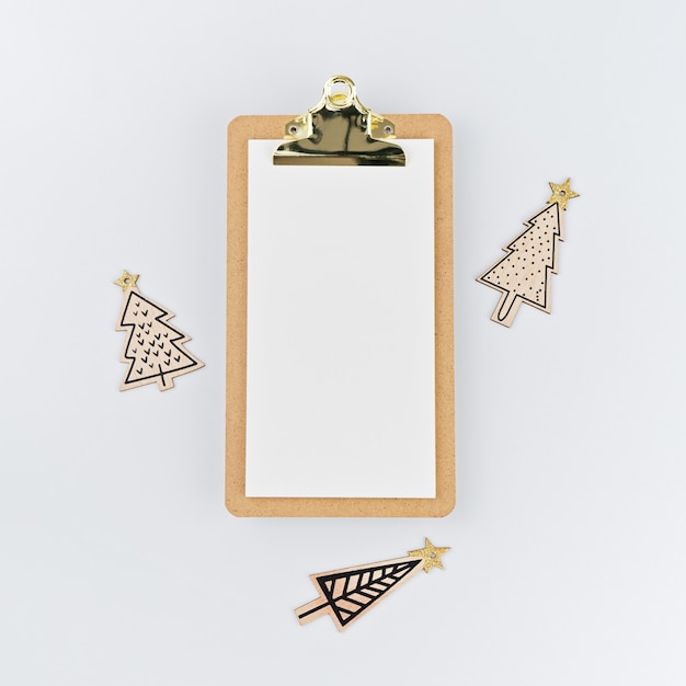 Blank on clipboard and wooden painted funny Christmas trees o