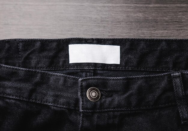 Blank clothing label on denim jeans texture Label with empty space for text