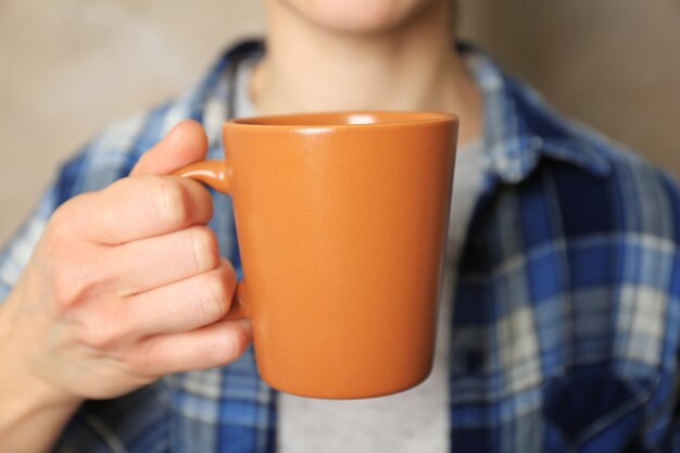 Blank color cup in hand closeup