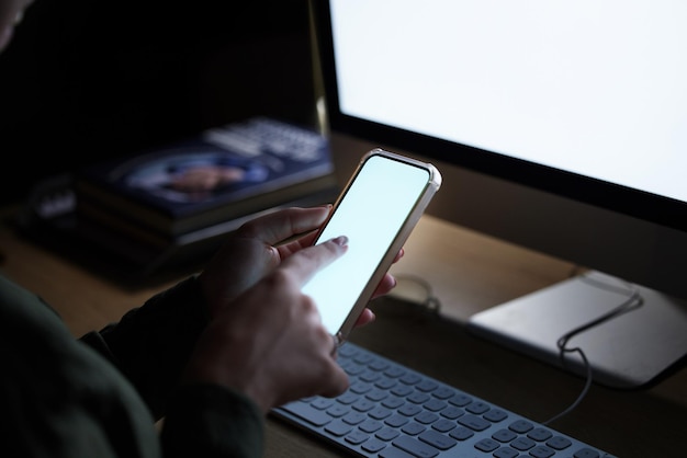 blank computer phone screen and woman hands typing on technology for coding mobile connection 404 glitch and programming on it software in the dark with a female coder employee at a office desk
