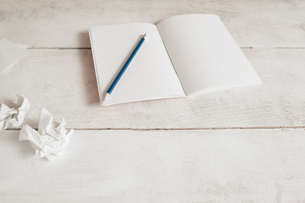 Blank copybook with pencil on table, free space.