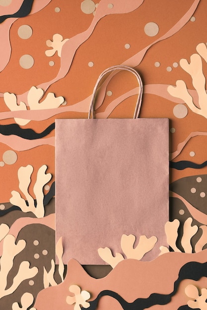 Blank craft paper bag on abstract sea underwater background. matisse-inspired craft paper collage.