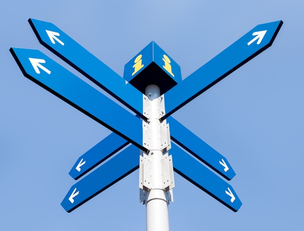 Blank directional road signs over blue sky