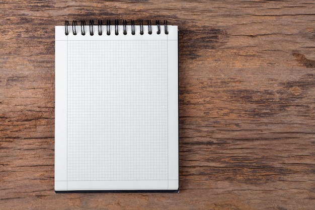 Blank empty notepad on wood background