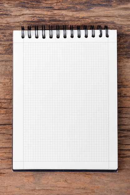 Blank empty notepad on wood background