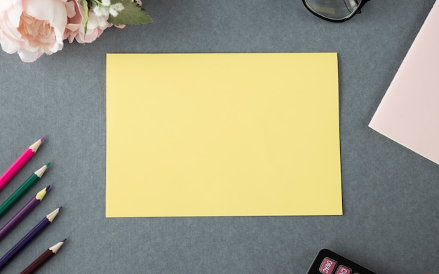 Blank empty yellow paper mock up on a wooden table in outdoor.