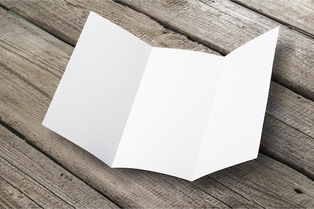 Blank folded card on wooden background
