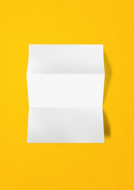 Blank folded White A4 paper sheet mockup template isolated on yellow background