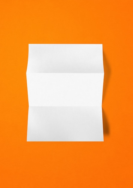 Blank folded White paper sheet on orange