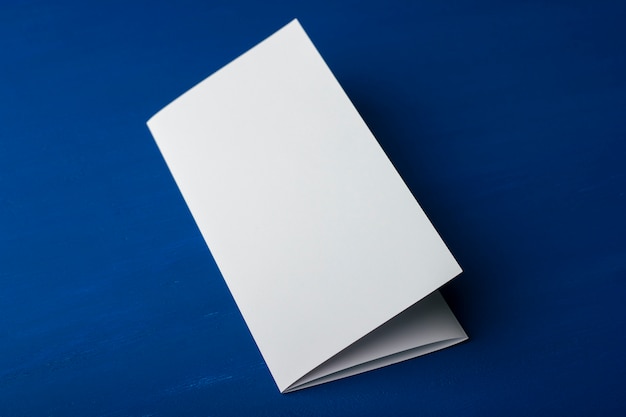 Blank folding brochure on blue background