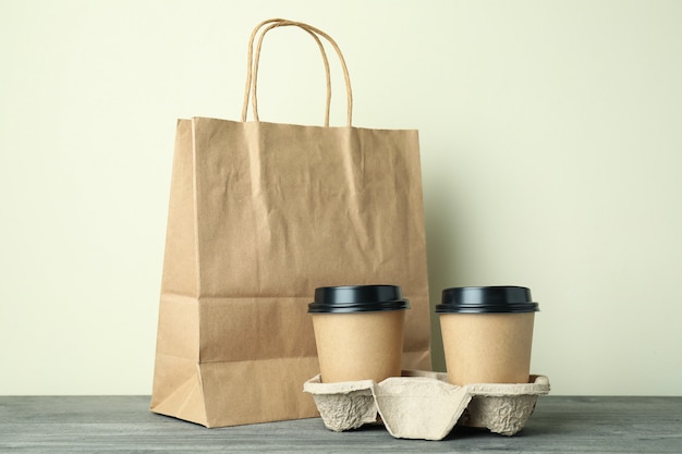 Blank food delivery packages on gray textured table