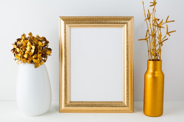 Blank frame with golden vase