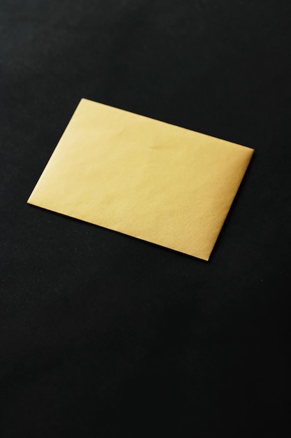 Blank golden paper card on black background business and luxury
brand identity mockup