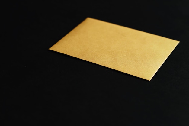 Blank golden paper card on black background business and luxury\
brand identity mockup