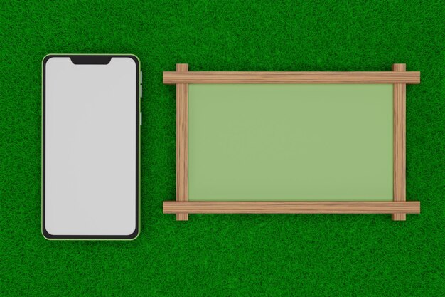 Photo blank green phone and board on grass field