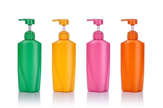 Blank green, yellow, pink and orange plastic pump bottle used for shampoo or soap.