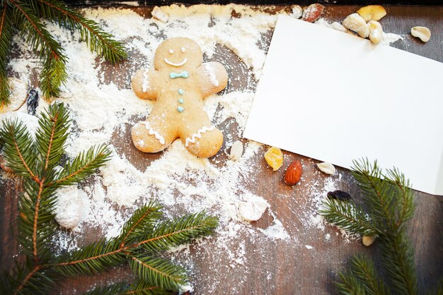 Blank greeting card with gingerbread man on table