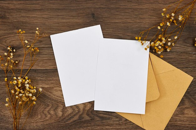 Blank greeting cards flyer or invitation card mockup with gypsophila flowers brown craft envelope