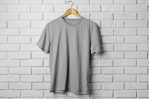 Photo blank grey tshirt against brick wall