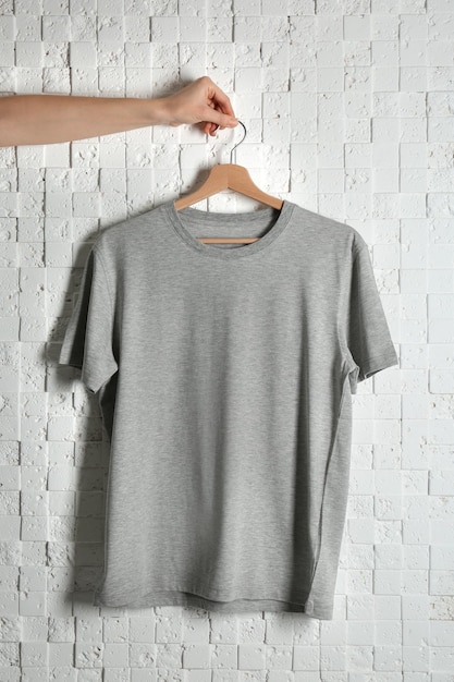 Photo blank grey tshirt against light textured background