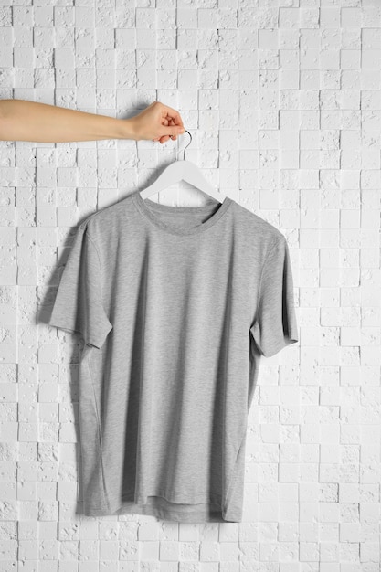 Photo blank grey tshirt against light textured background