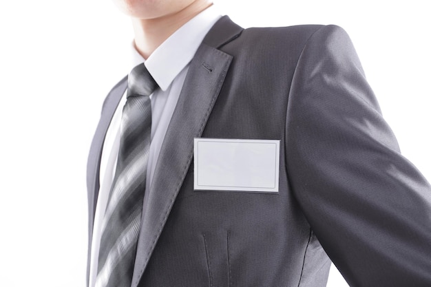 Blank identity tag hanging from a businessmans suit