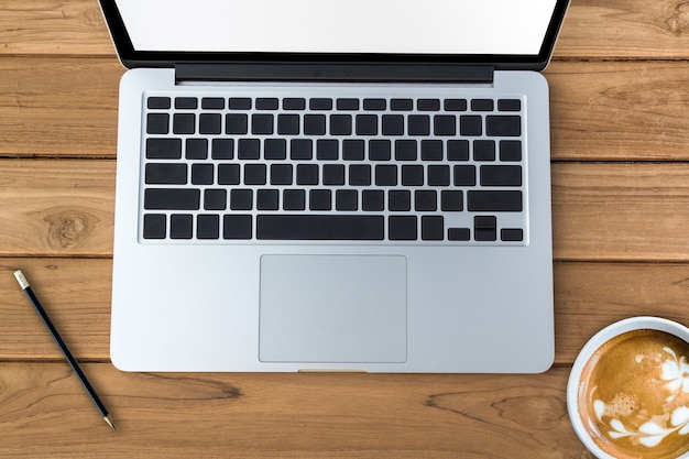  blank keyboard laptop with coffee on wood table 