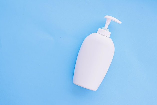 Blank label cosmetic container bottle as product mockup on blue background