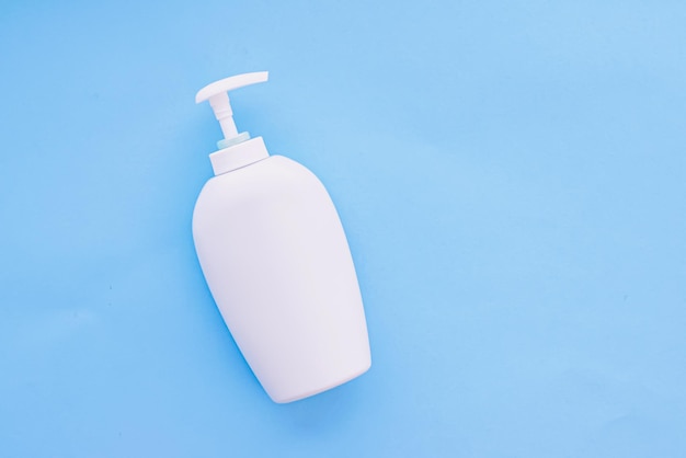 Blank label cosmetic container bottle as product mockup on blue background